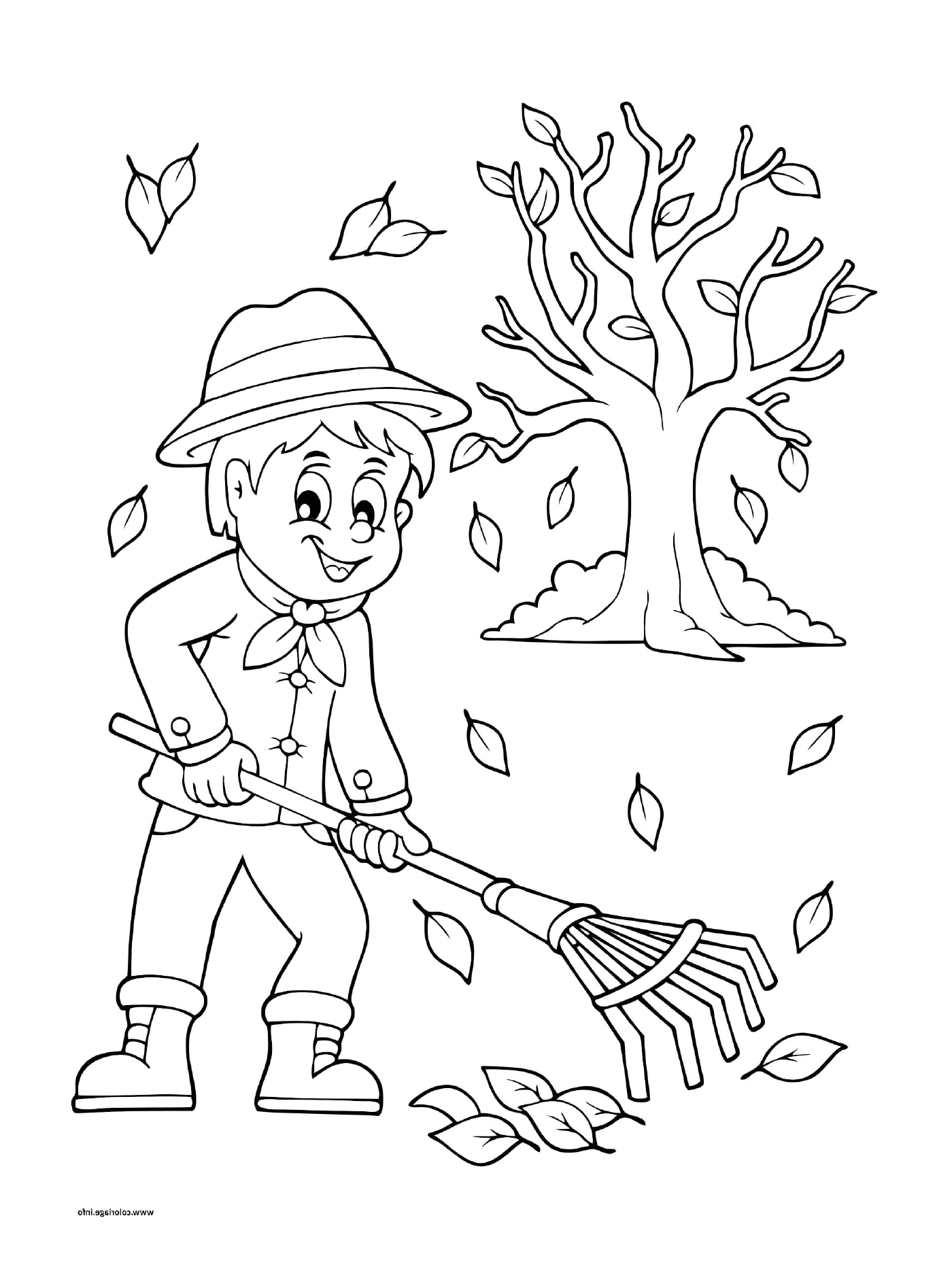  Ein Junge rattet die Blätter im Herbst 
