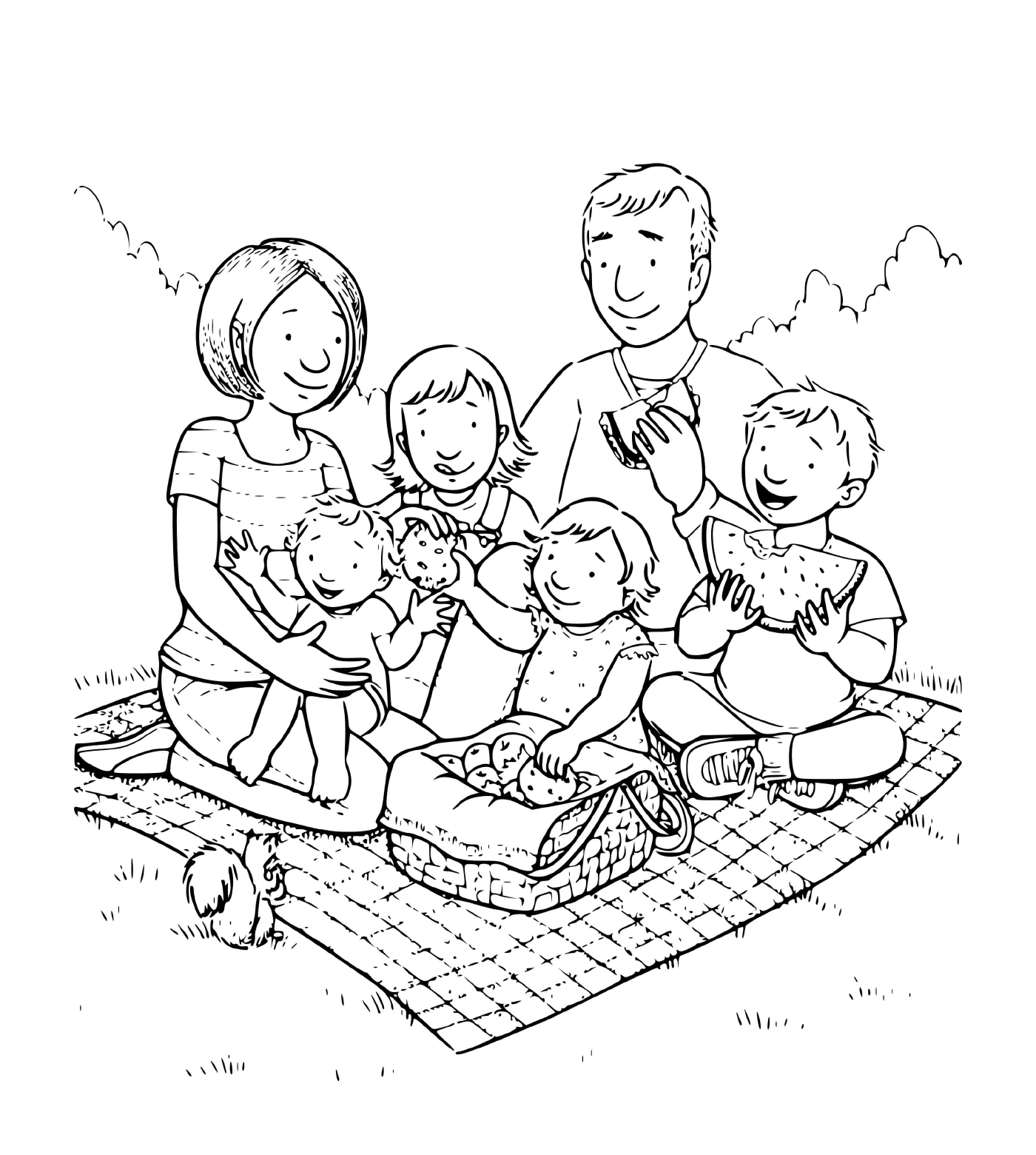  A family of four children taking a picnic on a blanket in the grass 