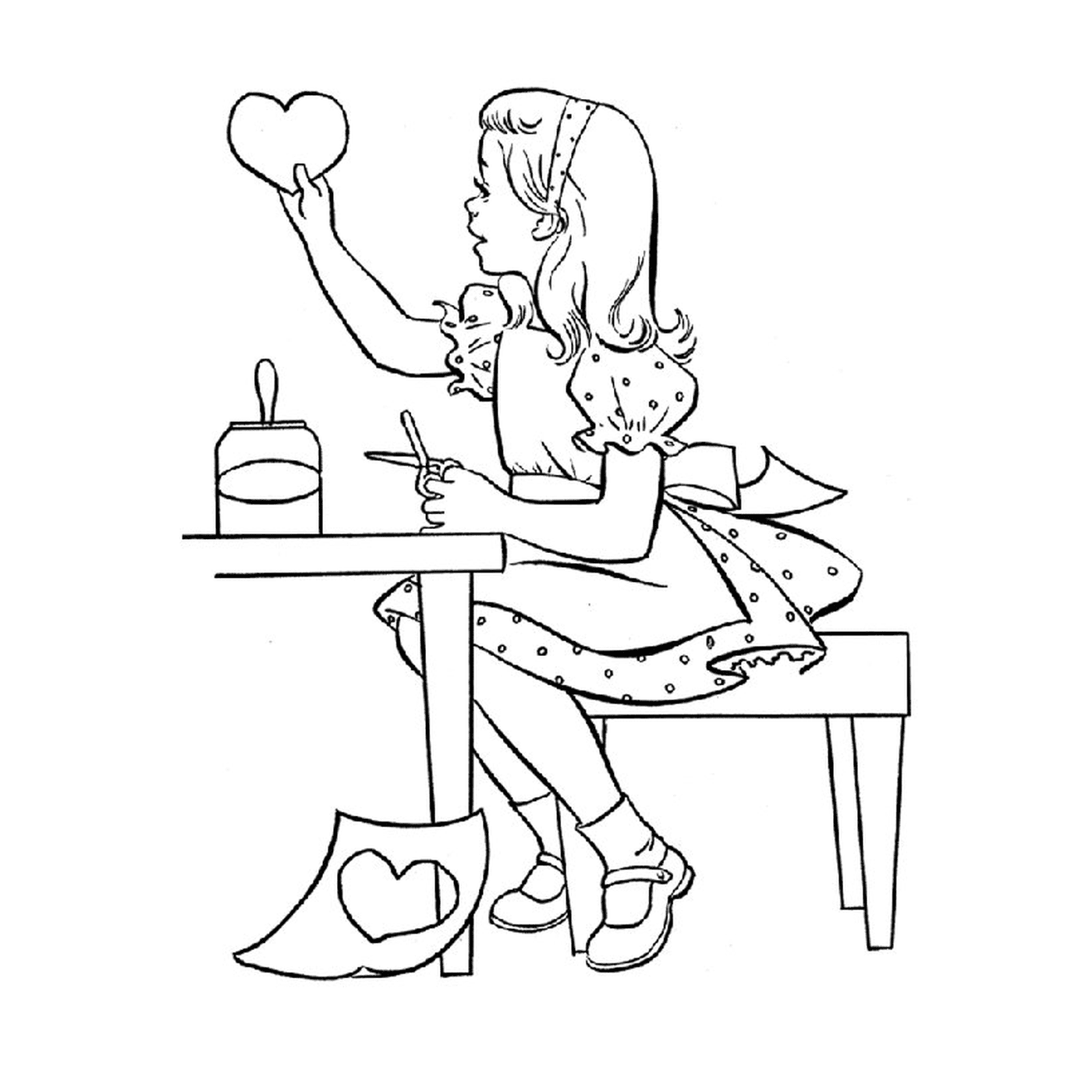  A woman sitting at a table holding a heart 