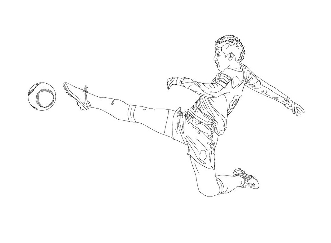 Un chico pateando en una pelota de fútbol