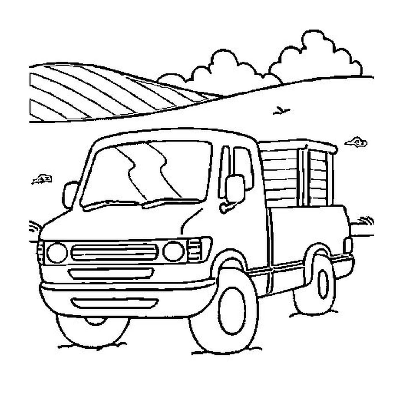  A truck parked in a field near a hill 